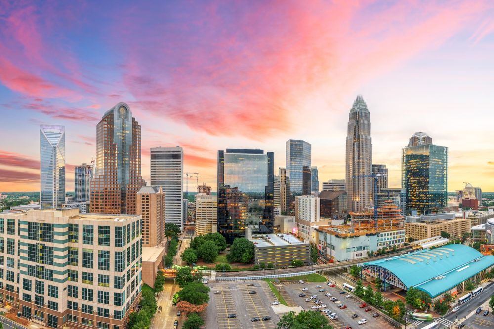 Skyline of downtown Charlotte, North Carolina at sunset with vibrant sky and modern skyscrapers.