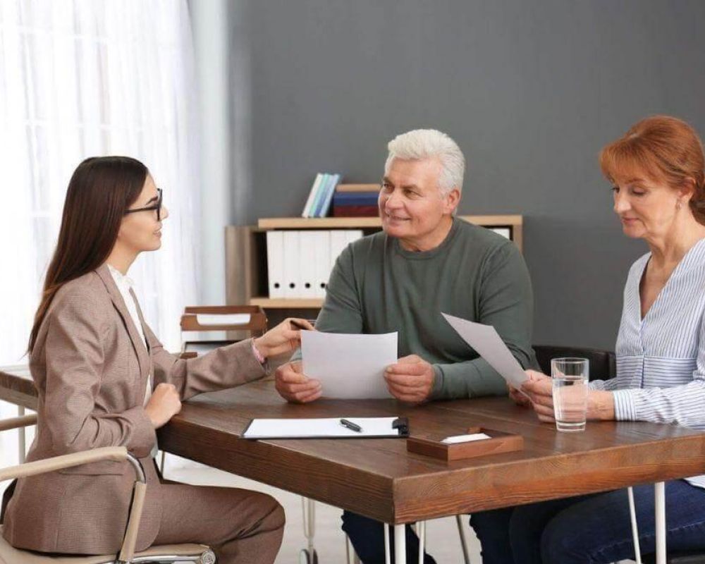 two women and a man sitting at a table