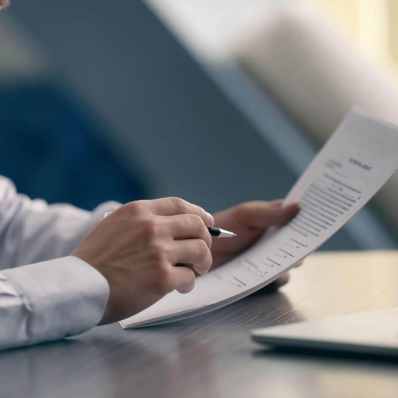 a man sitting at a desk with a pen and paper