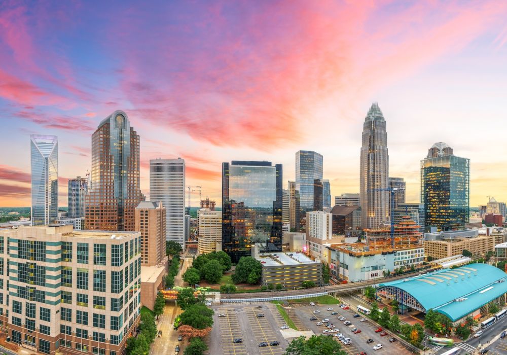 Skyline of downtown Charlotte, North Carolina at sunset with vibrant sky and modern skyscrapers.