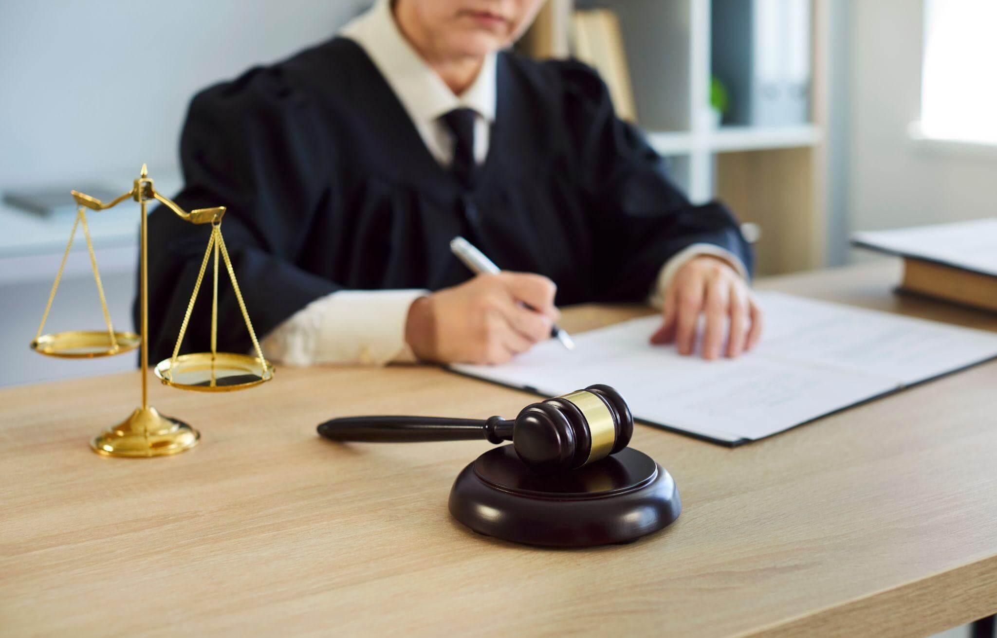 a judge sitting at a desk with a pen and paper