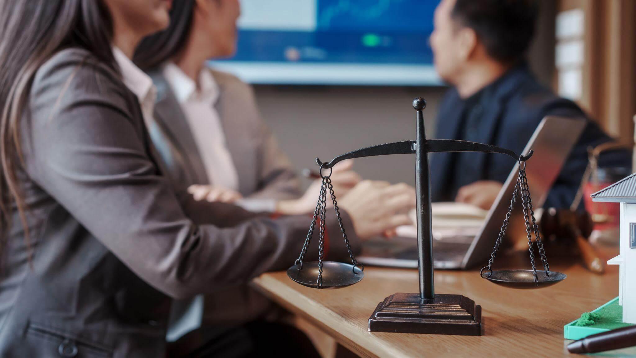 a woman holding a scale of justice in front of a man
