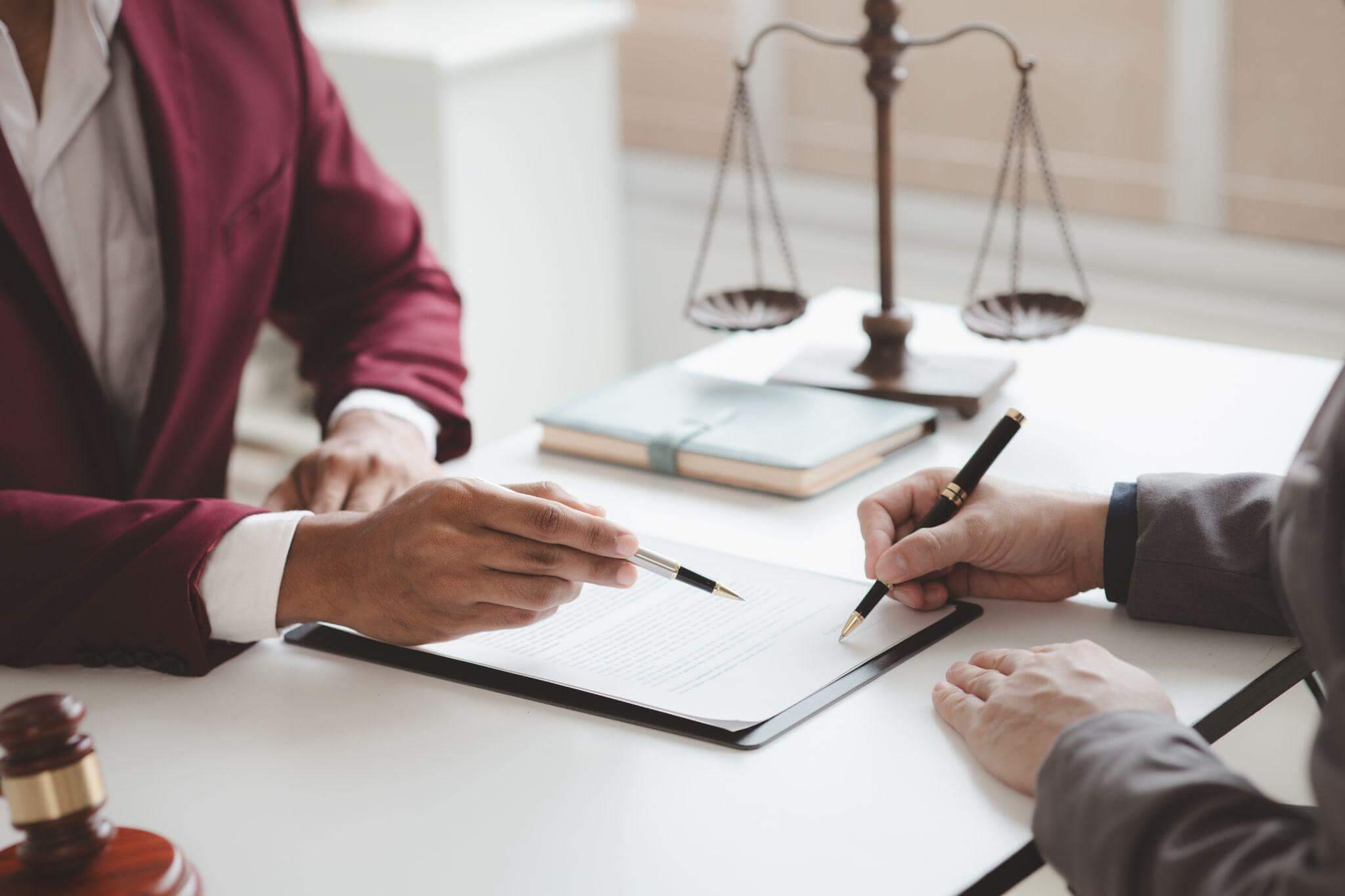 two people sitting at a table in front of a judge