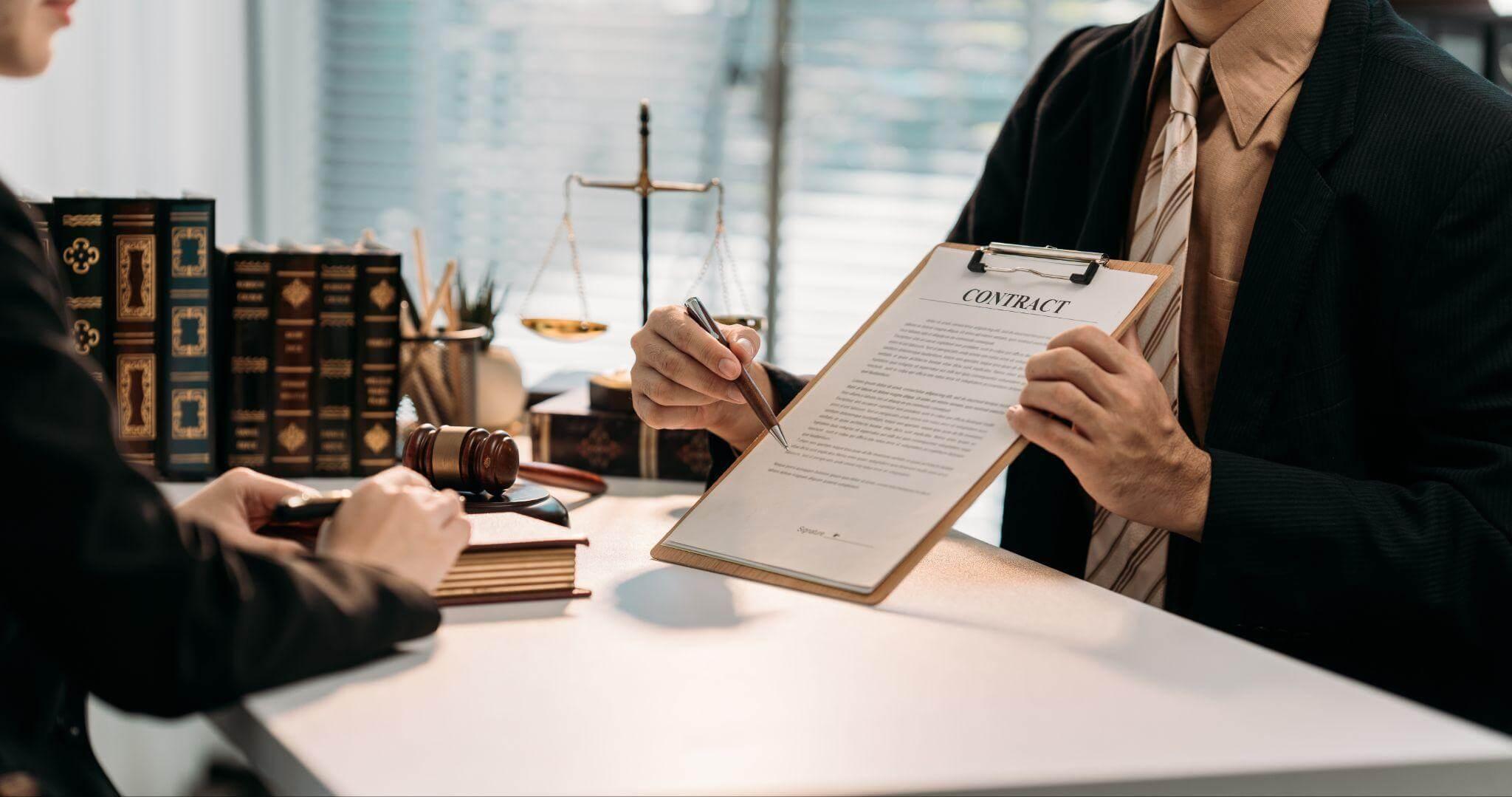 Attorney consults woman with clipboard on breach of