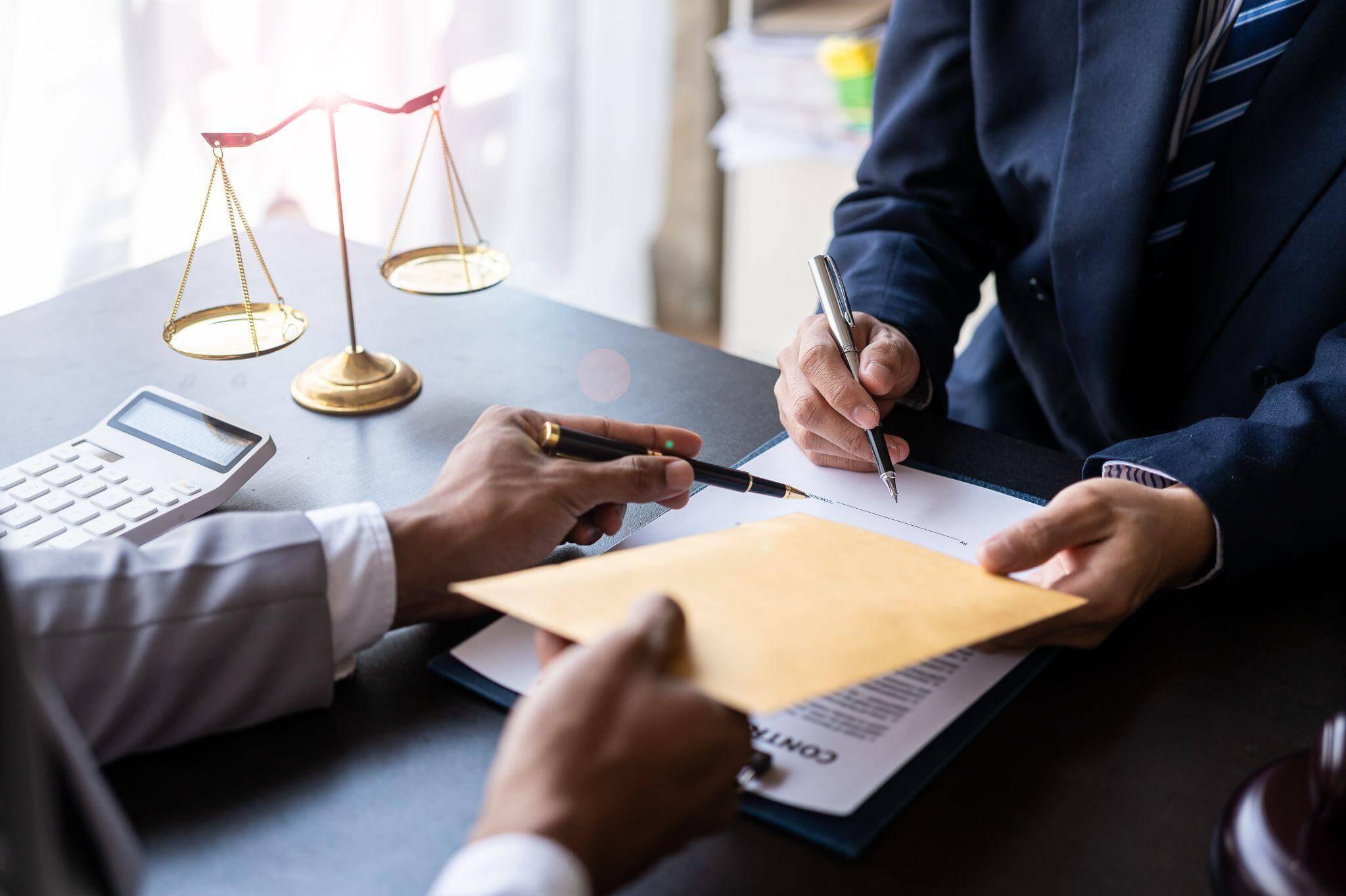 Client and North Carolina alimony attorney at a table