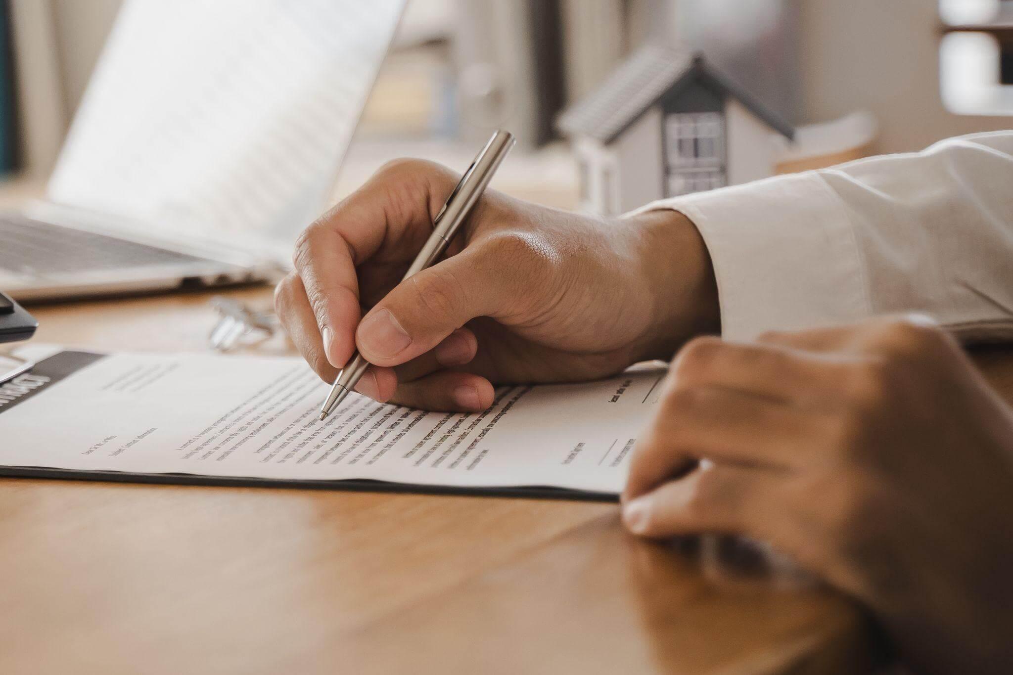 Person writing notes related to a breach of