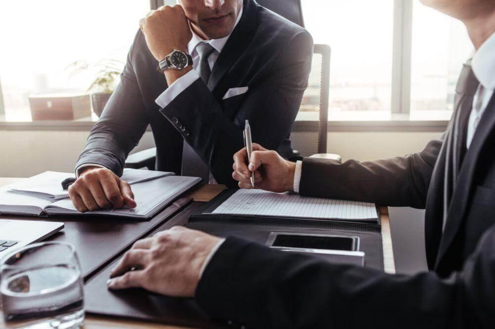 Two men discussing business dissolution with an attorney