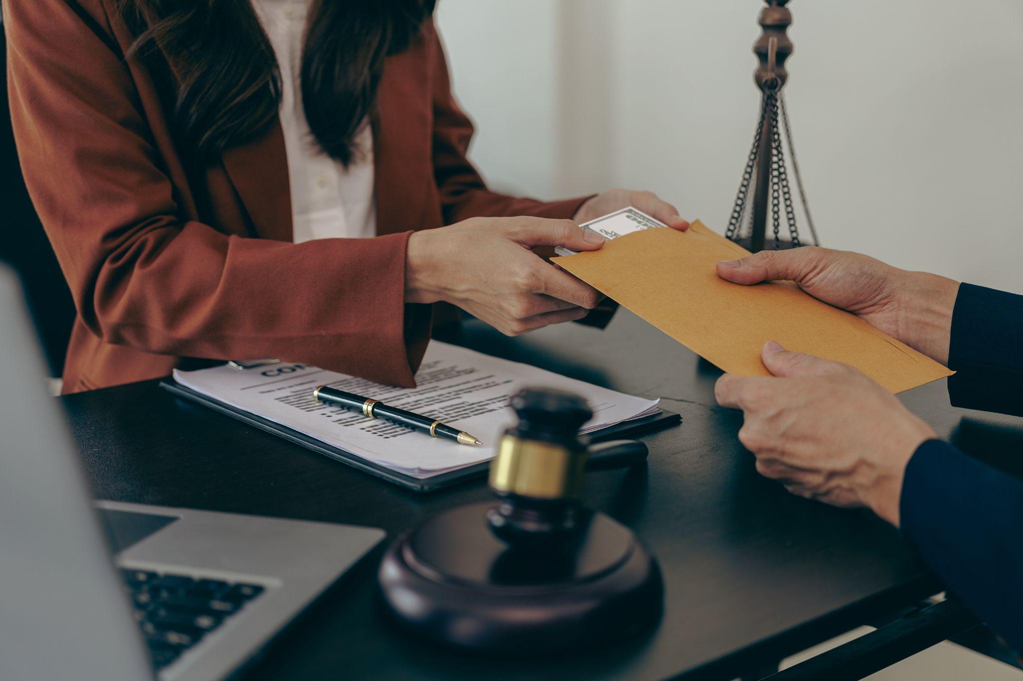 Two people shaking hands over a document, client review