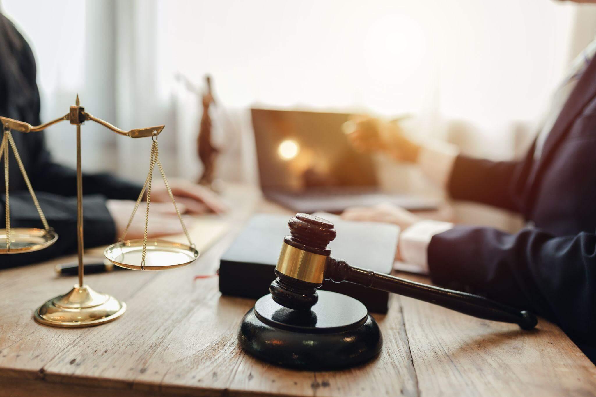 Judge and scale of justice on wooden