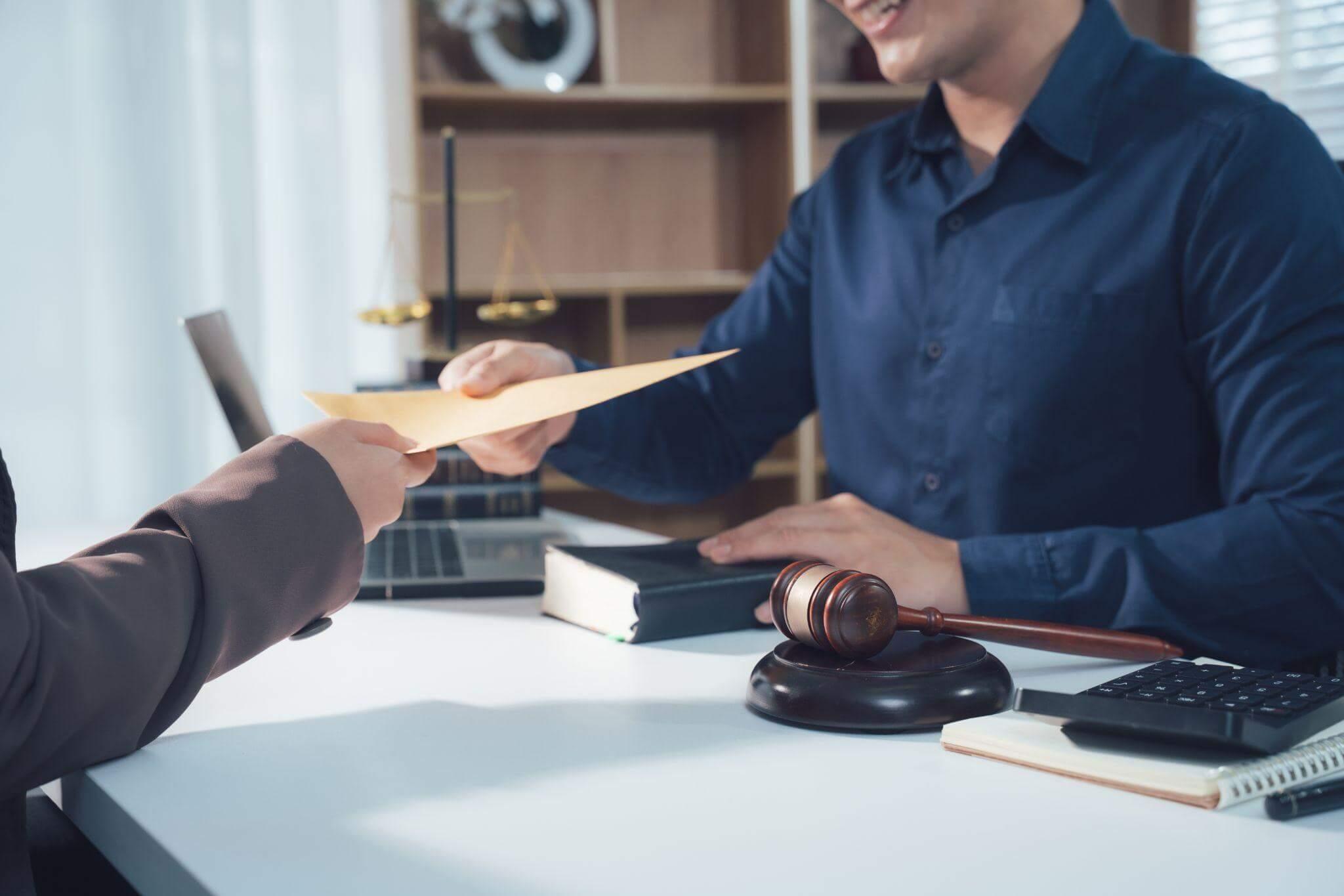 Estate planning attorney handing client important document