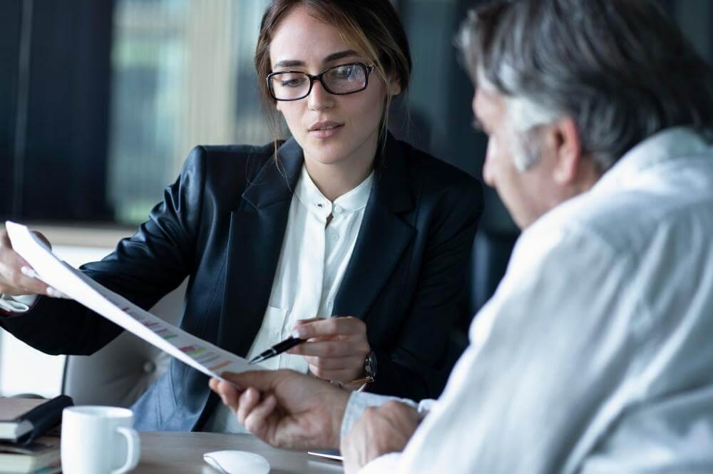 Man and woman discussing LLC dissolution with a client