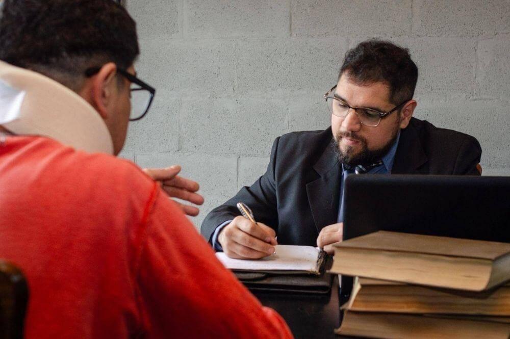 Man reviewing notes, possibly a client working with drug