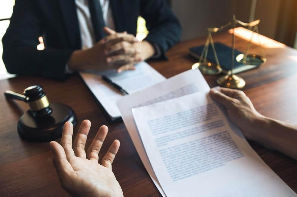Two people with papers and a judge